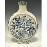A Chinese moon flask, painted in tones of underglaze blue with chrysanthemums and scrolling