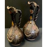 A near pair of 19th century Demoiselles d'Avignon' Canakkale Pottery ewers, in brown glaze decorated