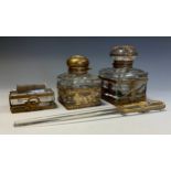 A neoclassical four piece desk set, two graduated inkwells, letter knife and roller, cast gilt metal