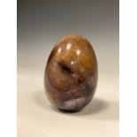 A Derbyshire Blue John Fluorspar novelty desk weight, as an egg, 6.2cm long, 4.1cm wide, 186.4g,