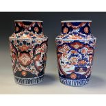 A pair of Japanese fluted ovoid vase, painted in the Imari palette with flowers and foliage, 25cm