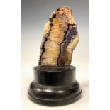 A Blue John mineral slice, mounted as a desk weight 12.2cm high, ebonised base