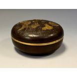 A Japanese brown patinated bronze and mixed metal bun shaped box and cover, in relief with elders,