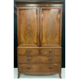 A Regency mahogany linen press, moulded cornice above a pair of panel doors, the base with two short