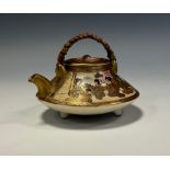 A Japanese Meiji period Satsuma tea pot, compressed circular form, two panel decoration, scholars to