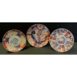 A Japanese Meiji period imari plates, decorated with insects, serpent and flowers, 30cm diameter.
