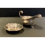 A George V silver sauce boat, Birmingham 1919; shaped octagonal dish, Addie Bros, Birmingham 1948,