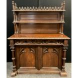 A Victorian oak Gothic Revival Chiffonier, carved and pierced three-quarter galleried top with
