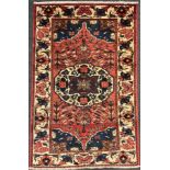 A central Persian Bakhtiar rug / carpet, hand-knotted in muted tones of red, blue, and cream,