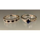 A diamond and sapphire ring, central oval deep blue sapphire above three stone diamond inset