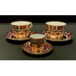 Two Royal Crown Derby, 1128 pattern tea cups and saucers, conforming coffee can and saucer (3)