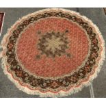 A Persian circular wool and silk rug, the central floral form medallion, enclosed within a