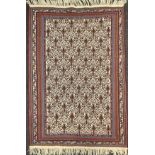 A Turkish Kilim rug, Hand-knotted with a broad central field of repeating stylised motifs,