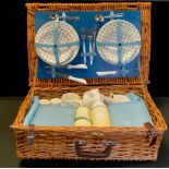 A wicket picnic basket, for four, with W H Grindley Petit Fleur pattern blue and white plates,