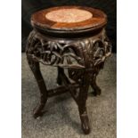 A 19th century Chinese hardwood stand, circular top with inset soapstone panel, above a deep