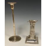 A silver candlestick, fluted column, weighted base, Birmingham 1902, 11.53ozt gross; an Arts and