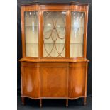 A Sheraton Revival satinwood shaped serpentine drawing room display cabinet, the projecting base