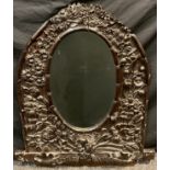 A carved oak framed wall mirror, arched intricately carved frames with Poppies, Lilies, Brambles,