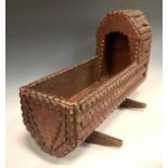 An American 'Tramp work' crib/rocking cradle, carved throughout, 36.5cm high, 50cm long, 27cm wide