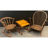 An Ercol ‘Cow-horn’ elm and beech-wood rocking chair, 66cm high x 56.5cm wide; an Ercol low arm-