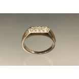 A diamond ring, pointed crest set with eight round brilliant cut diamonds, total estimated diamond