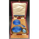 An Art Deco guilloche blue enamelled miniature vanity set, hand mirror, comb and brush, Levi &