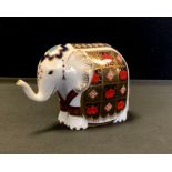 A Royal Crown Derby paperweight, Elephant, printed in the 1128 pattern, trunk raised, gold