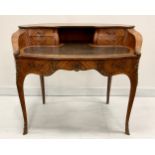 A Louis XV Revival gilt metal mounted mahogany desk, shaped serpentine superstructure with open