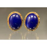 A pair of 18ct gold mounted lapis lazuli oval cabochon earrings, fixed pillar and clips, stamped