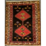 A North west Persian Heriz rug / carpet, hand-knotted in dark tones of red, blue, and green, on a