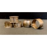 A Victorian silver napkin ring, London 1882, others later, 5.06ozt (5)