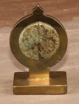 A 19th century brass pocket watch stand, incorporating a Chinese jade roundel, pierced and carved in