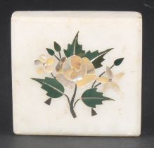 A pietra dura paperweight, inlaid in specimen stones and mother of pearl with a spray of flowers,
