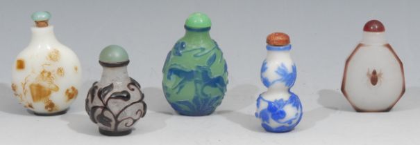 A Chinese Peking glass flattened ovoid snuff bottle, in cameo with a crane, horses, flowers and