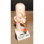 A German porcelain novelty caricature spill holder, For He's a Jolly Good Fellow...', 13.5cm high,