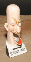 A German porcelain novelty caricature spill holder, For He's a Jolly Good Fellow...', 13.5cm high,