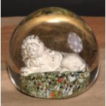A 19th century sulphite glass paperweight, the inclusion as a recumbent lion, 10cm high, c.1880
