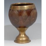 A 19th century brass mounted coconut cup, decorated with alternating hobnail roundels and