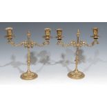 A pair of early 20th century gilt brass adjustable rise-and-fall two-light candelabra, 31cm high,