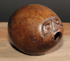 A 19th century coconut bugbear, carved with a grotesque face, 12cm long, c.1870