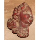 A 19th century wax applique, moulded as the head of a putto, 10cm long
