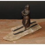 Continental School (early 20th century), a spelter figure, of a lady skiing, faux ice base, 18cm