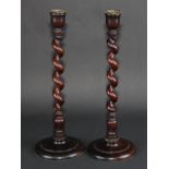 Treen - a pair of mahogany spirally turned table candlesticks, circular bases, 39cm high, early 20th