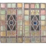 A pair of Arts & Crafts period leaded stained glass rectangular panels, each with central bullseye