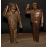 Folk Art - a pair of carved figures, Napoleonic soldiers, each standing to attention, 41cm high,