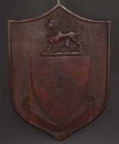 A 19th century oak armorial shield, carved in relief with the arms and motto of Urwick, 42.5cm x