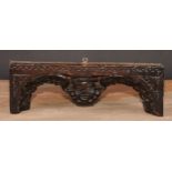 An early English oak carving, centred by a mask with arched and plumed wings, lunette border, 28cm