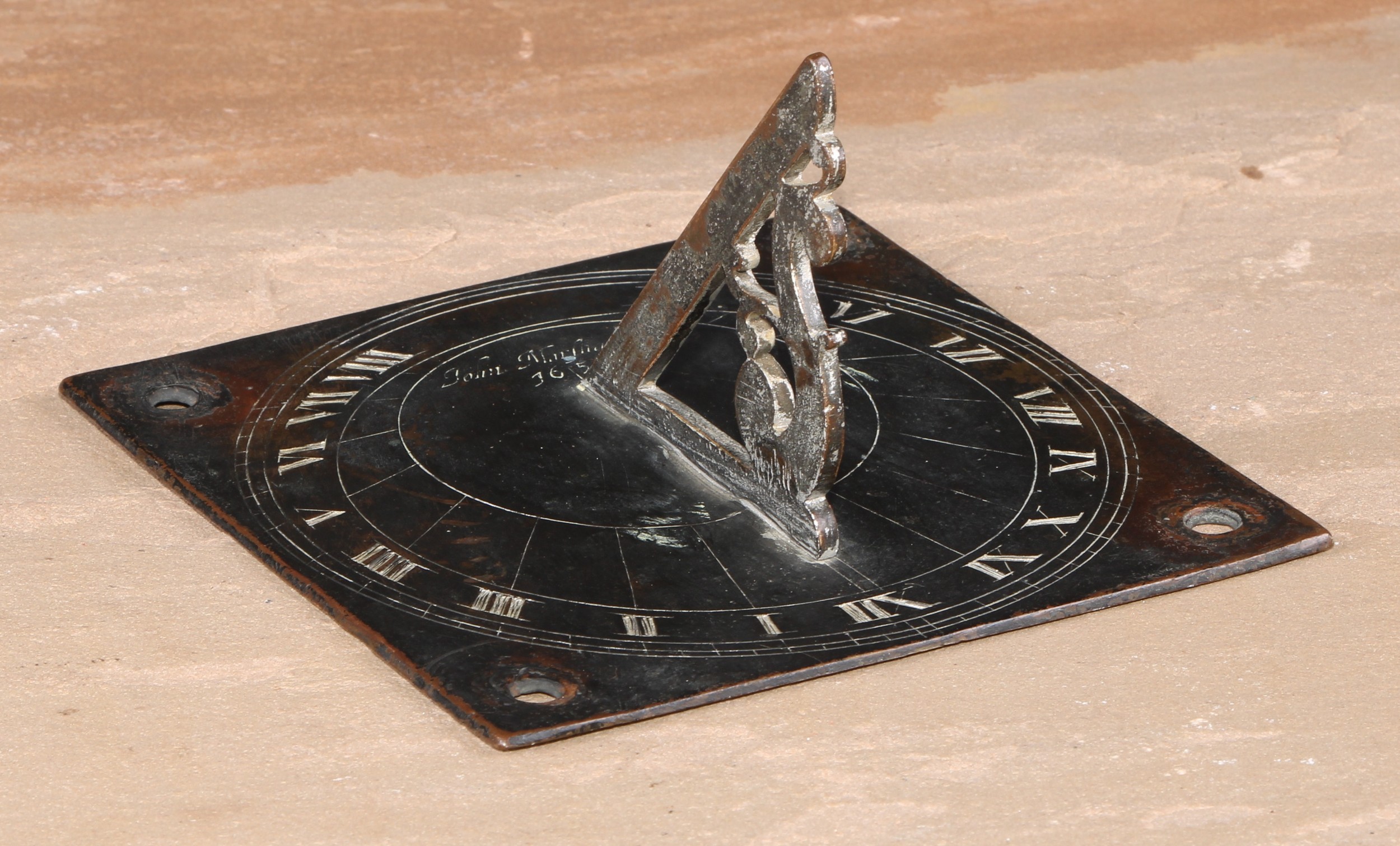 A bronze sundial, inscribed John Marshsll 1656, Roman numerals, shaped gnomon, 14.5cm wide