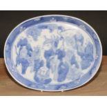 A Chinese oval tray, decorated in tones of underglaze blue with a dense arrangement of figures, 24.