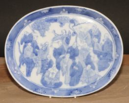 A Chinese oval tray, decorated in tones of underglaze blue with a dense arrangement of figures, 24.